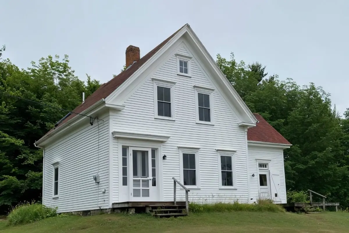 Meta Goldin Farmhouse — front view across the meadow